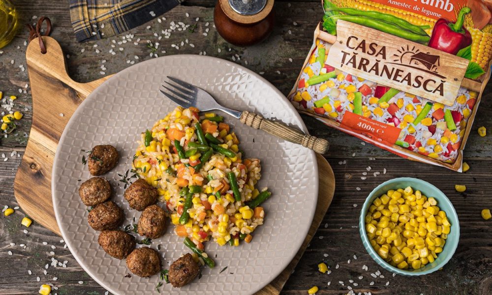 Baked meatballs with a side dish of vegetables and rice and corn