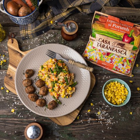 Baked meatballs with a side dish of vegetables and rice and corn